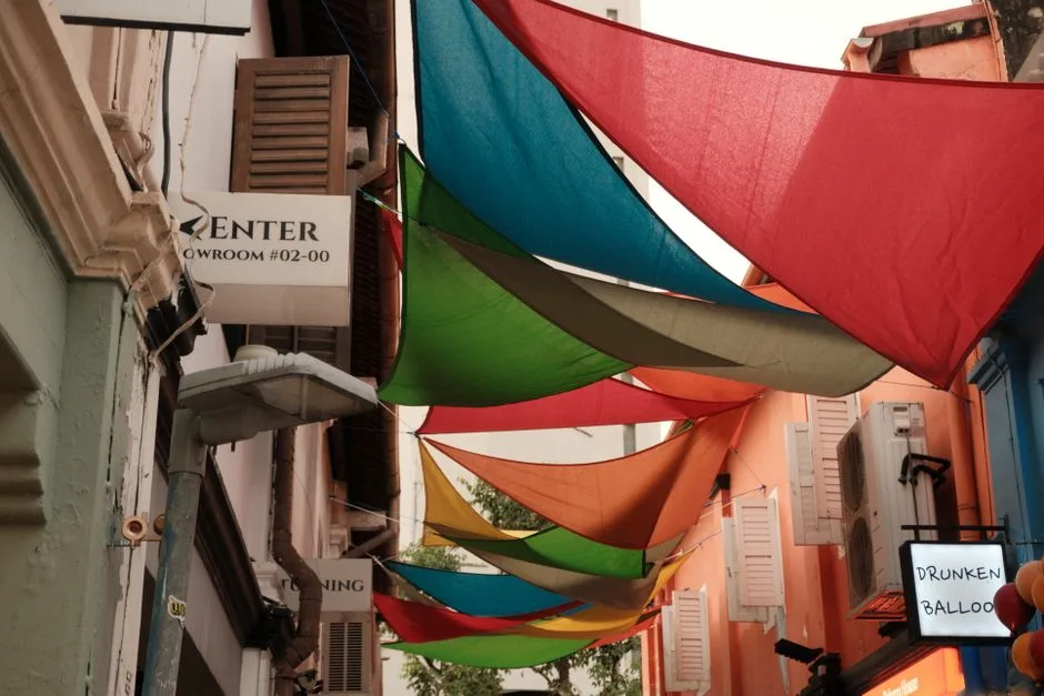 Vibrant colored canopies over a Singapore street, creating an artistic and lively atmosphere.