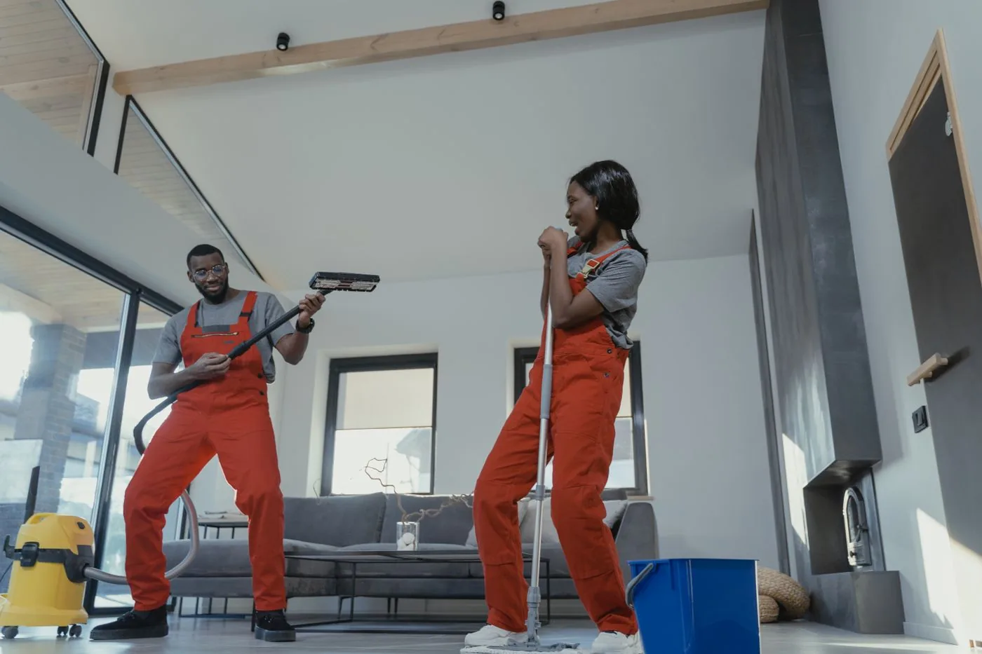 Janitorial team with vacuum and mop in a modern living space. Photo by Tima Miroshnichenko on Pexels
