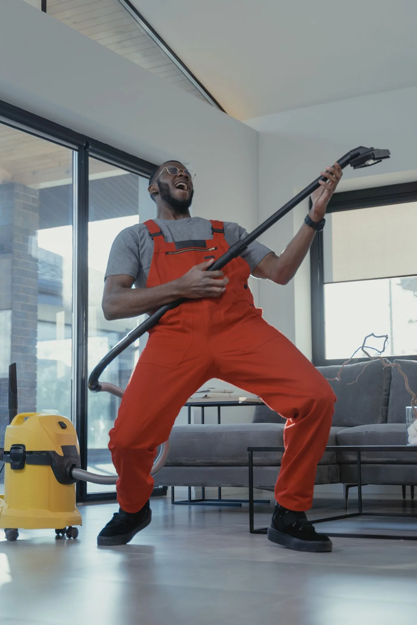 Professional cleaner vacuuming during a residential service visit. Photo by Tima Miroshnichenko on Pexels
