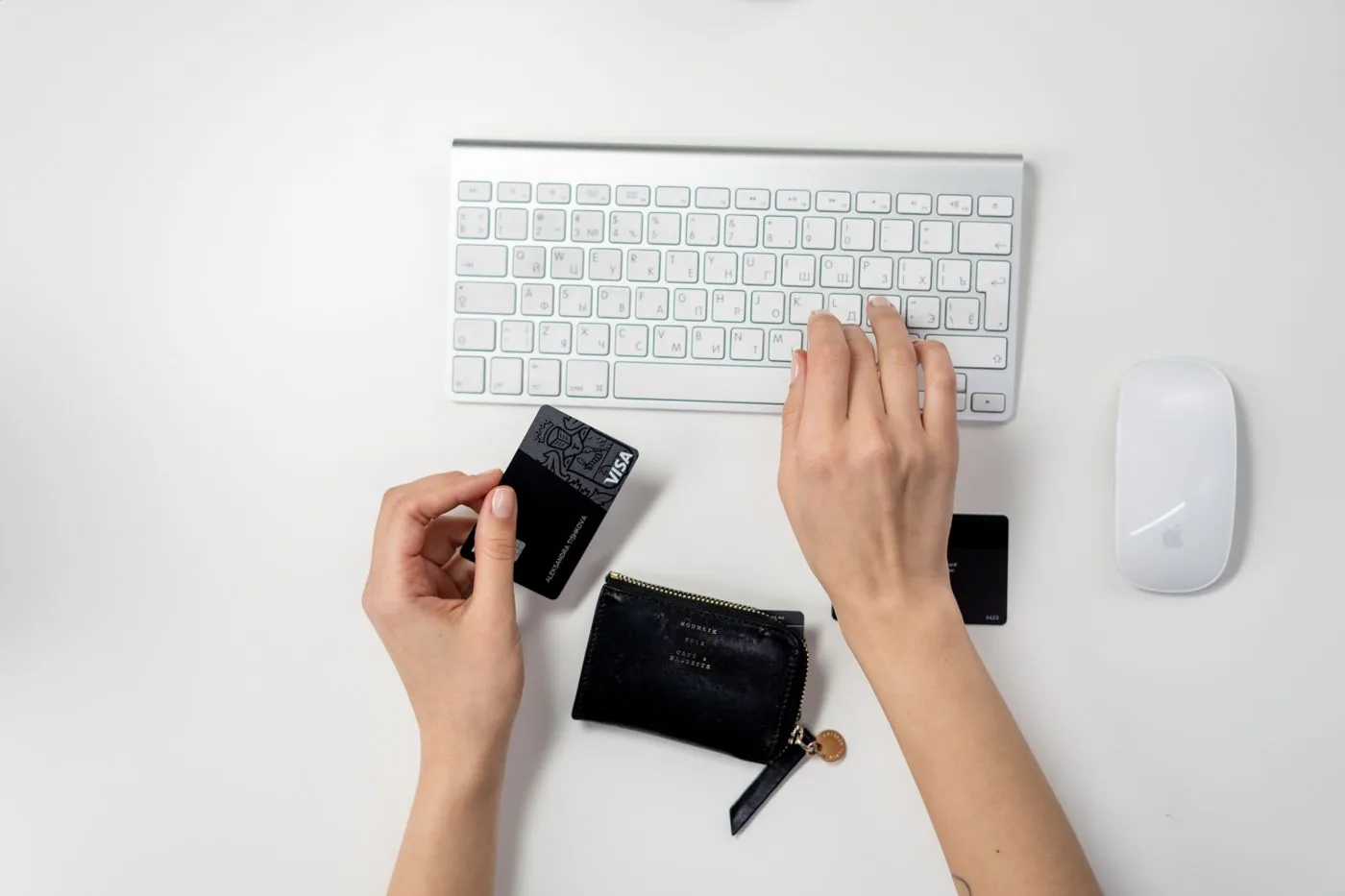 Shopper paying online with a card at a computer keyboard. Photo by cottonbro studio on Pexels
