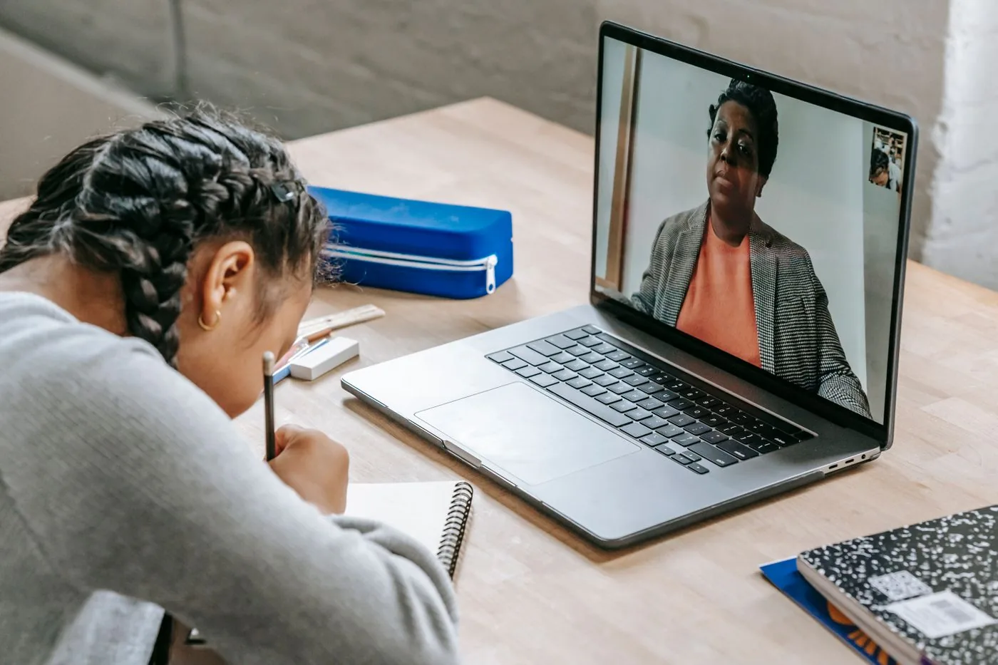 Student taking notes during an online lesson on a laptop. Photo by Katerina Holmes on Pexels