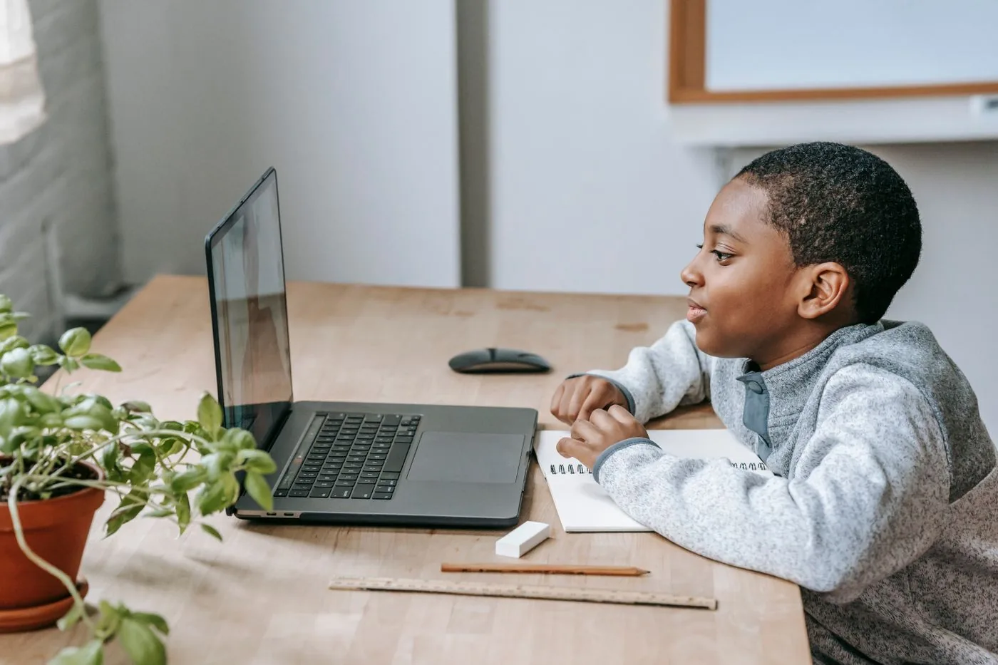 Young learner researching a course on a laptop at a desk. Photo by Katerina Holmes on Pexels
