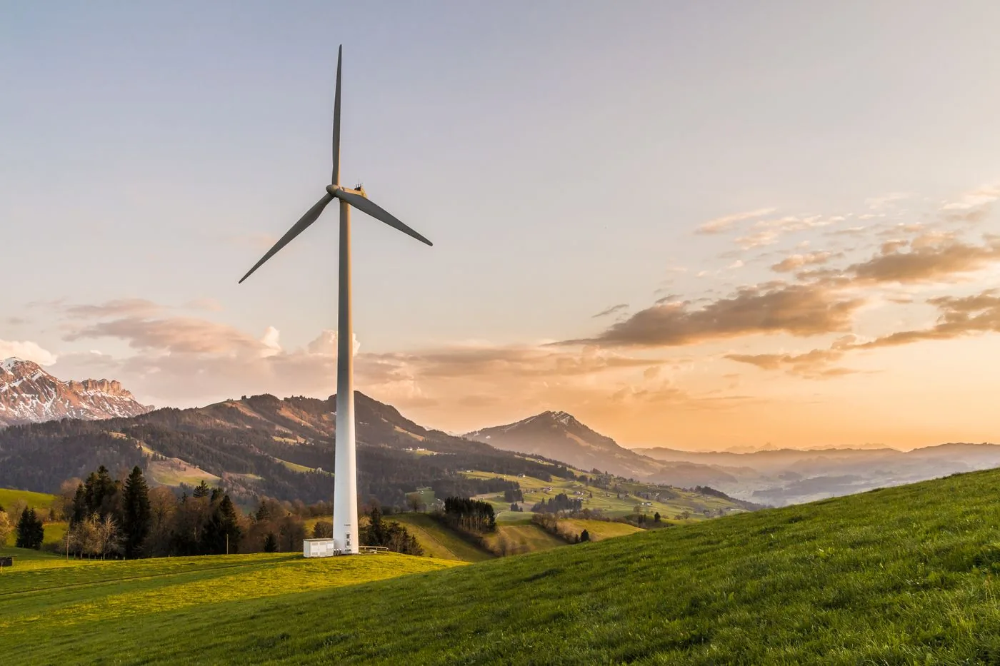 Wind turbine on a hillside representing energy cost and resilience education. Photo by Pixabay on Pexels