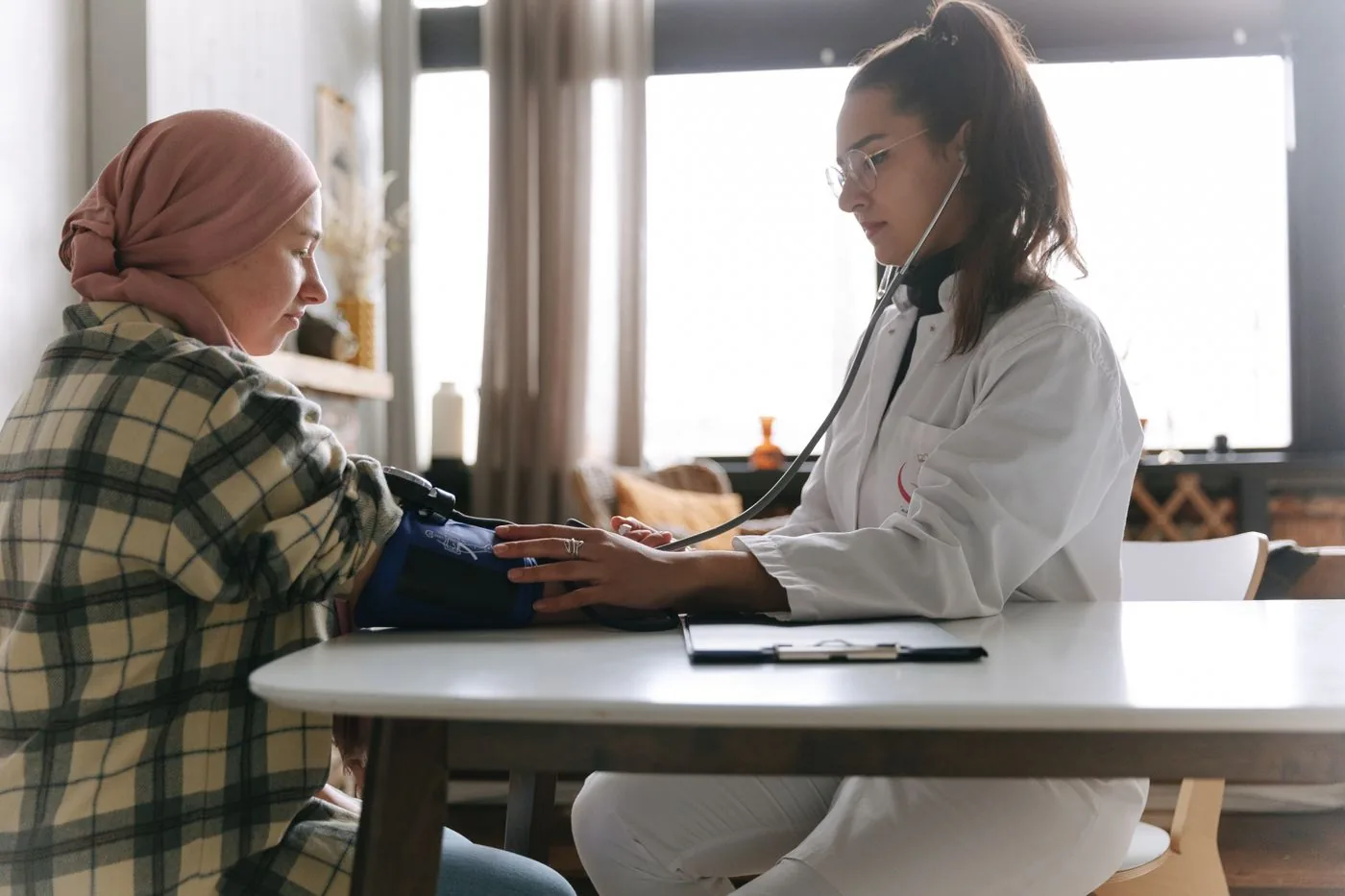 Healthcare professional checking a patient blood pressure carefully. Photo by Thirdman on Pexels
