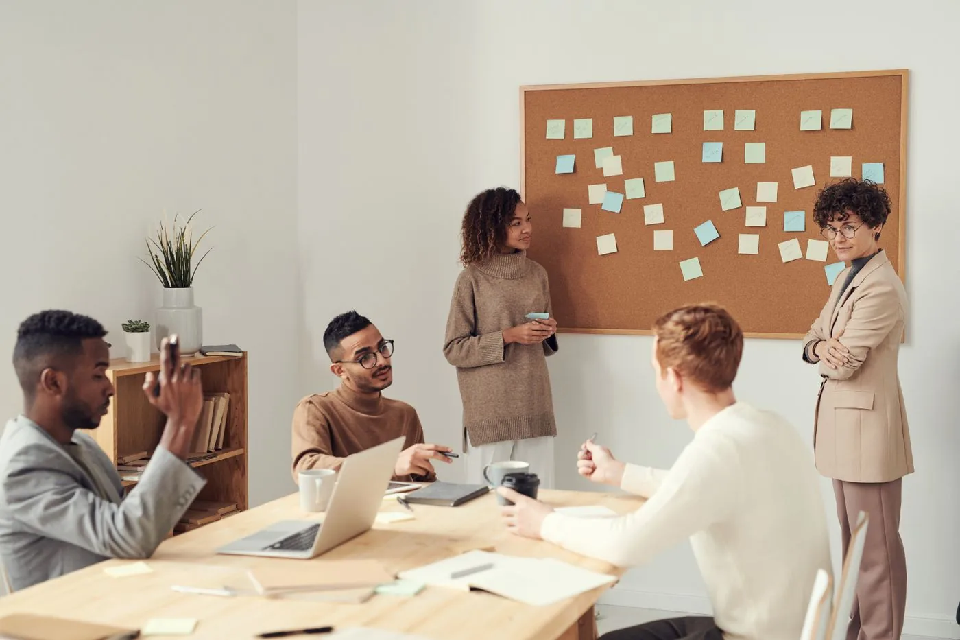 SaaS leadership team celebrating predictable revenue growth. Photo by fauxels on Pexels