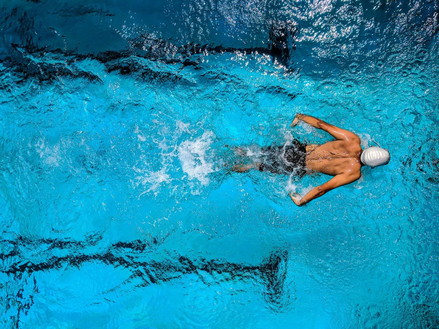Swimmer training in a pool representing active participation. Photo by Guduru Ajay bhargav on Pexels