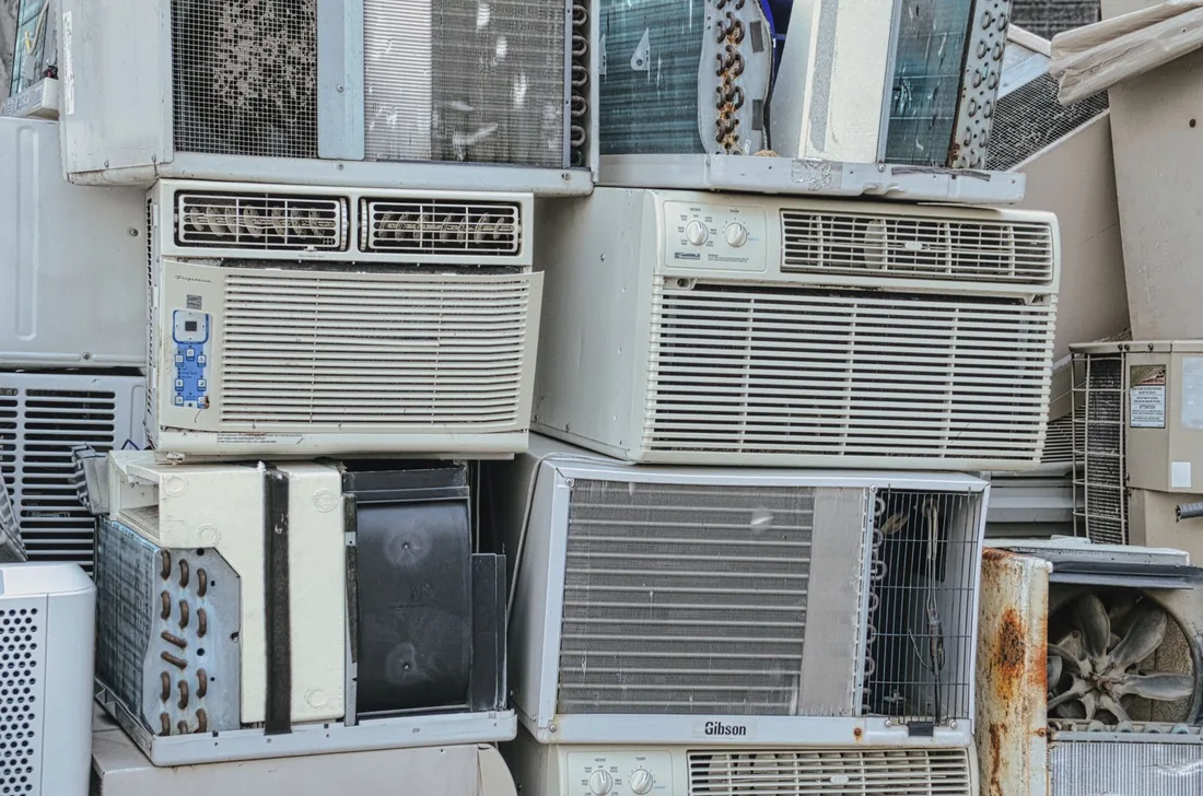 A pile of old window air conditioners awaits recycling, illustrating electronic waste issues in Singapore. Photo by Tom Fisk on Pexels