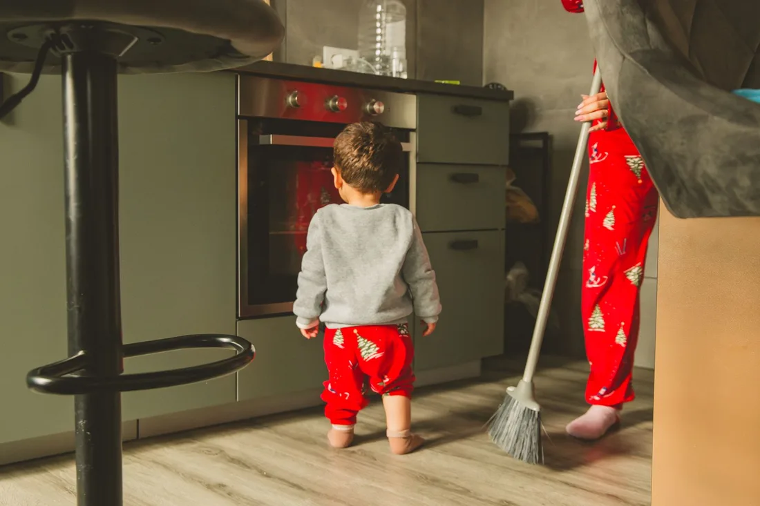 Cute toddler and adult in a kitchen wearing matching Christmas pajamas in the UK. Photo by Letícia Fracalossi on Pexels
