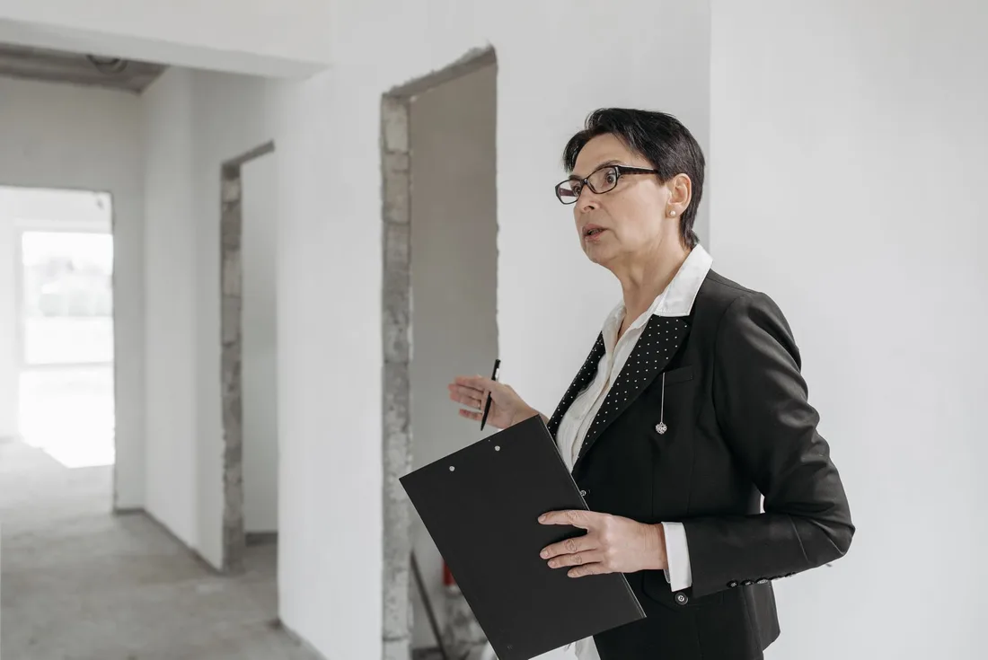 Woman in a suit holding a clipboard, inspecting an unfinished indoor construction site in Australia. Photo by Pavel Danilyuk on Pexels