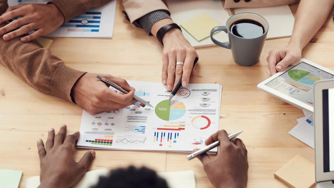Colleagues reviewing charts in a B2B meeting, the buyers Microsoft Ads reaches. Photo by fauxels on Pexels