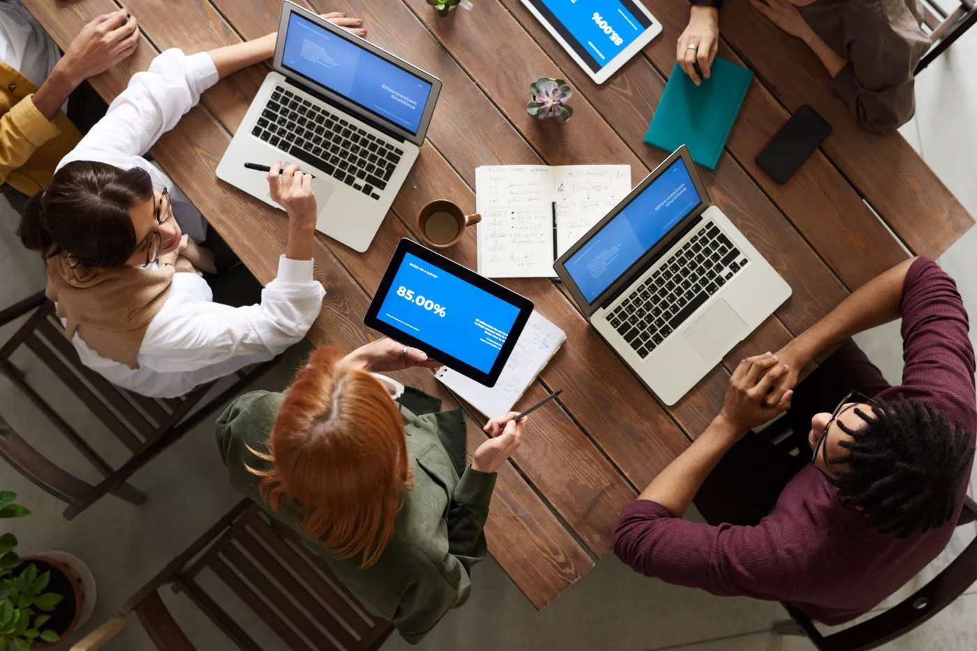 Marketing team planning paid search campaign structure on laptops