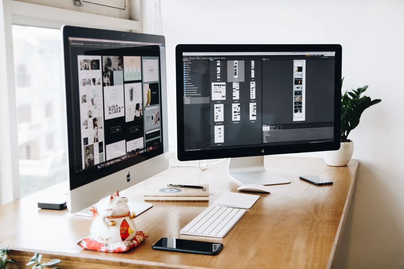 Dual monitors showing UI design work in progress